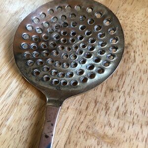 Brass vintage spoon with hole for hanging slotted 14 inches long